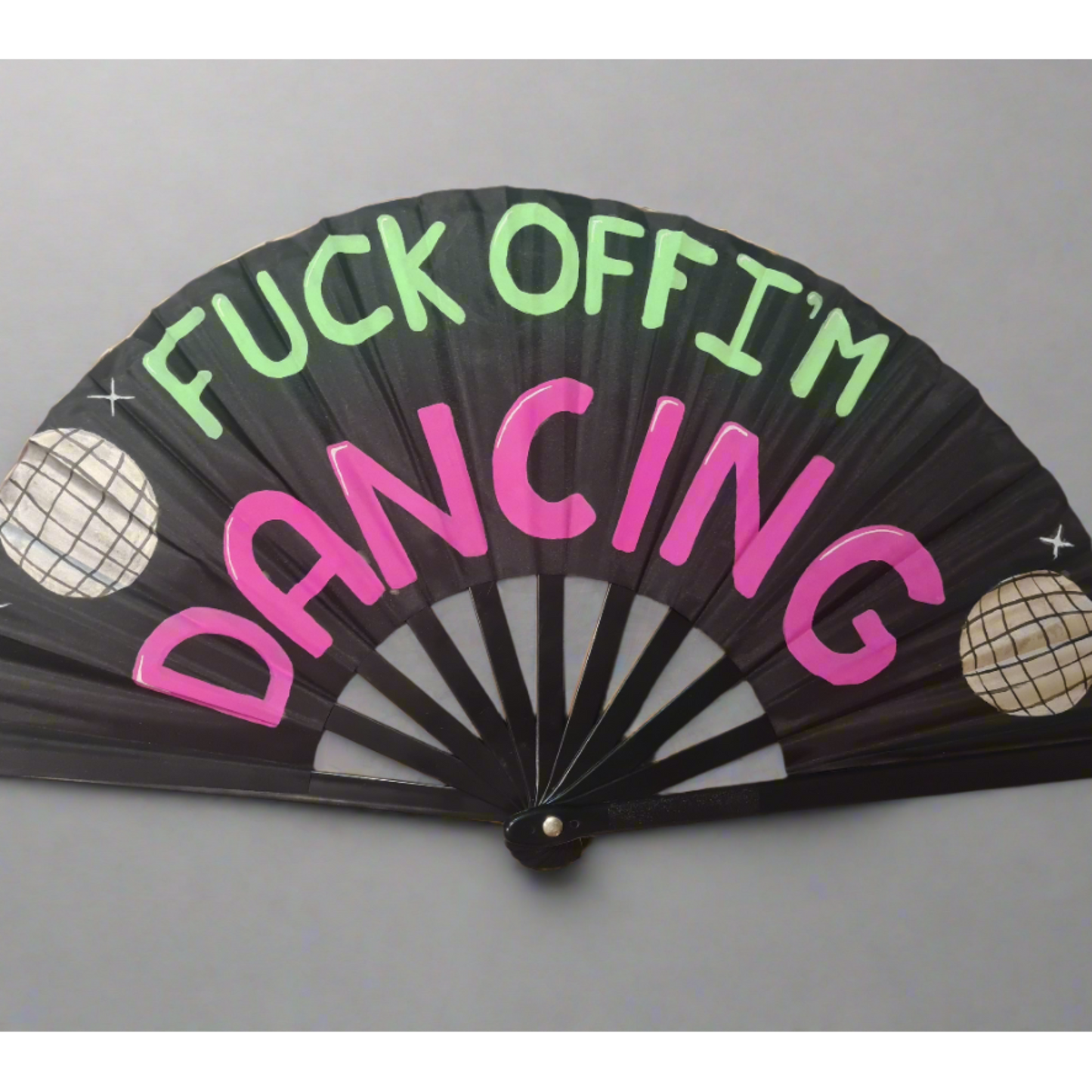 Fuck Off I'm Dancing UV Fan, black handpainted with green and purple lettering, silver discoballs and white stars, UV reactive for festivals and raves