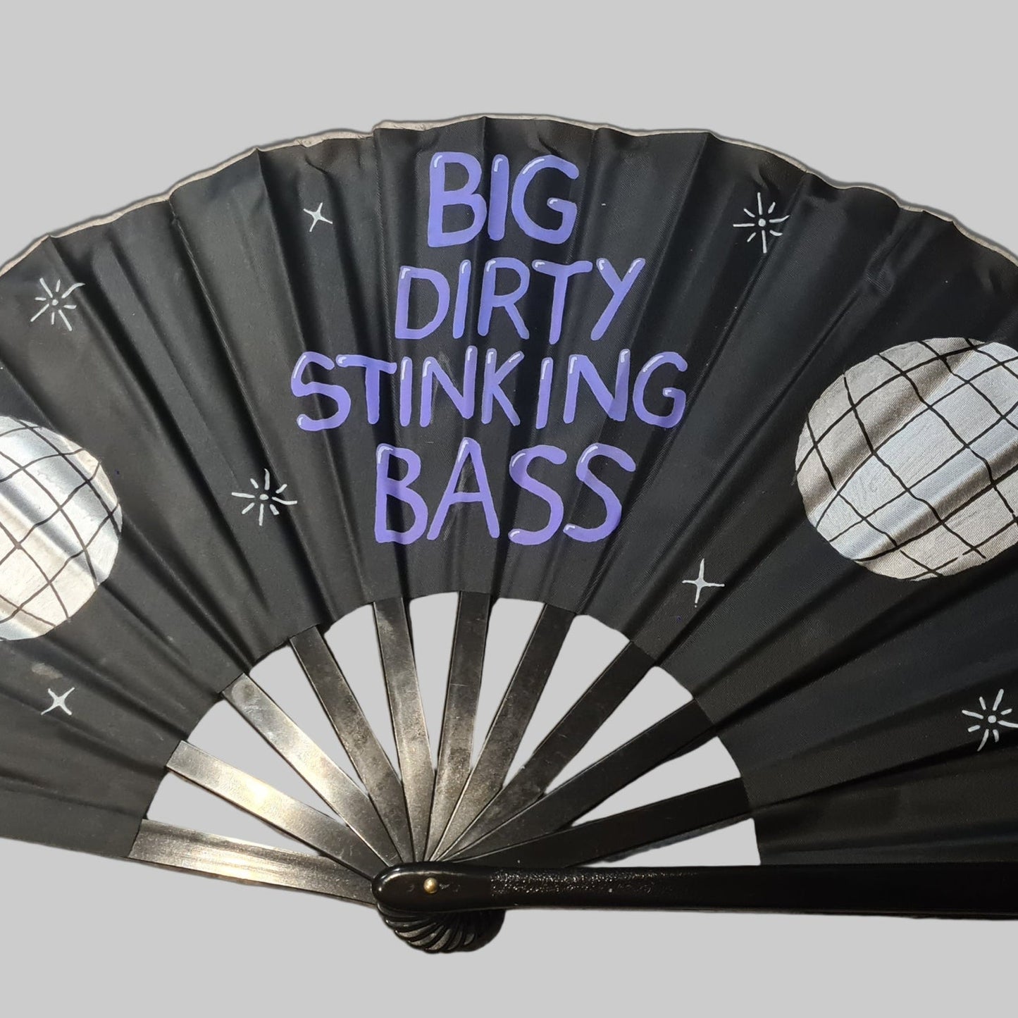 Big Dirty Stinking Bass UV Fan, black handpainted with purple lettering, silver discoballs and white stars, UV reactive for festivals and raves