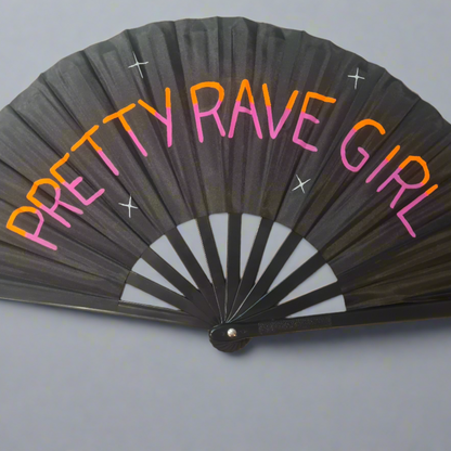 Pretty Rave Girl UV Fan, black handpainted with orange and pink lettering and white star, UV reactive for festivals and raves
