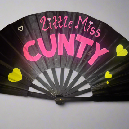 Little Miss Cunty UV Fan, black handpainted with pink lettering, yellow and white hearts, UV reactive for festivals and raves
