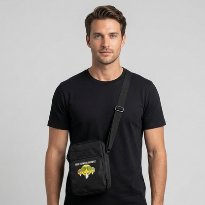 Male model wearing the black Secret Society crossbody bag on a neutral studio background