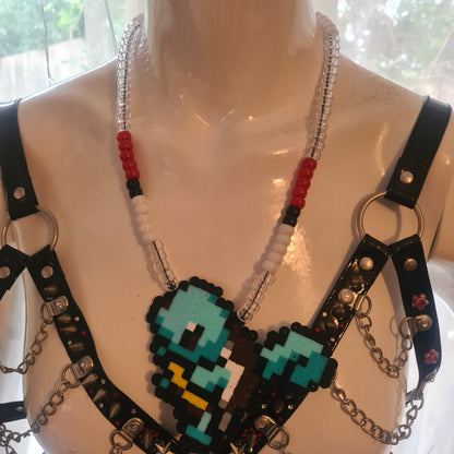 Pixelated character necklace on mannequin