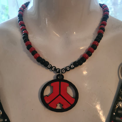 Necklace with red, black, and blue beads on a white surface