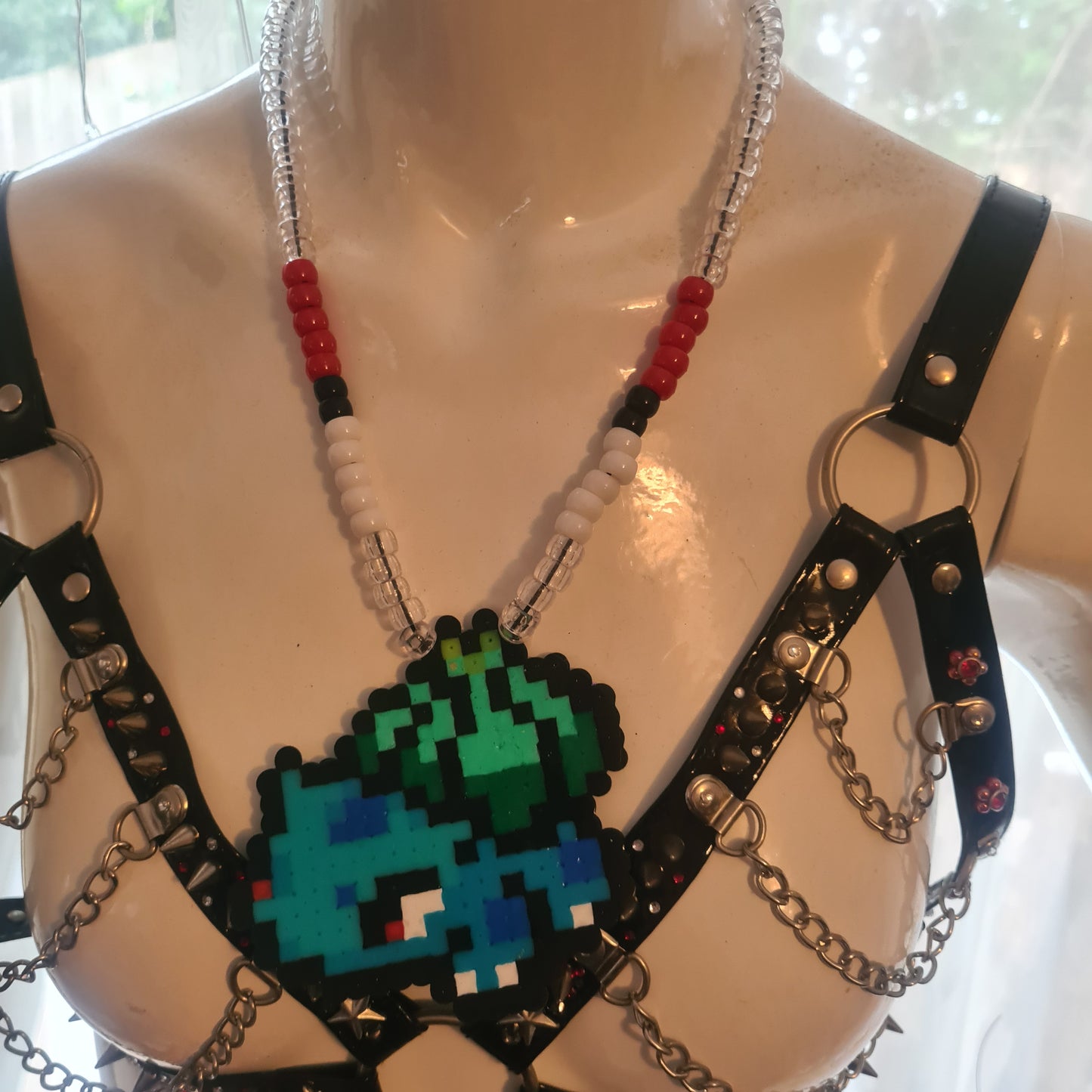 Pixelated character necklace on mannequin