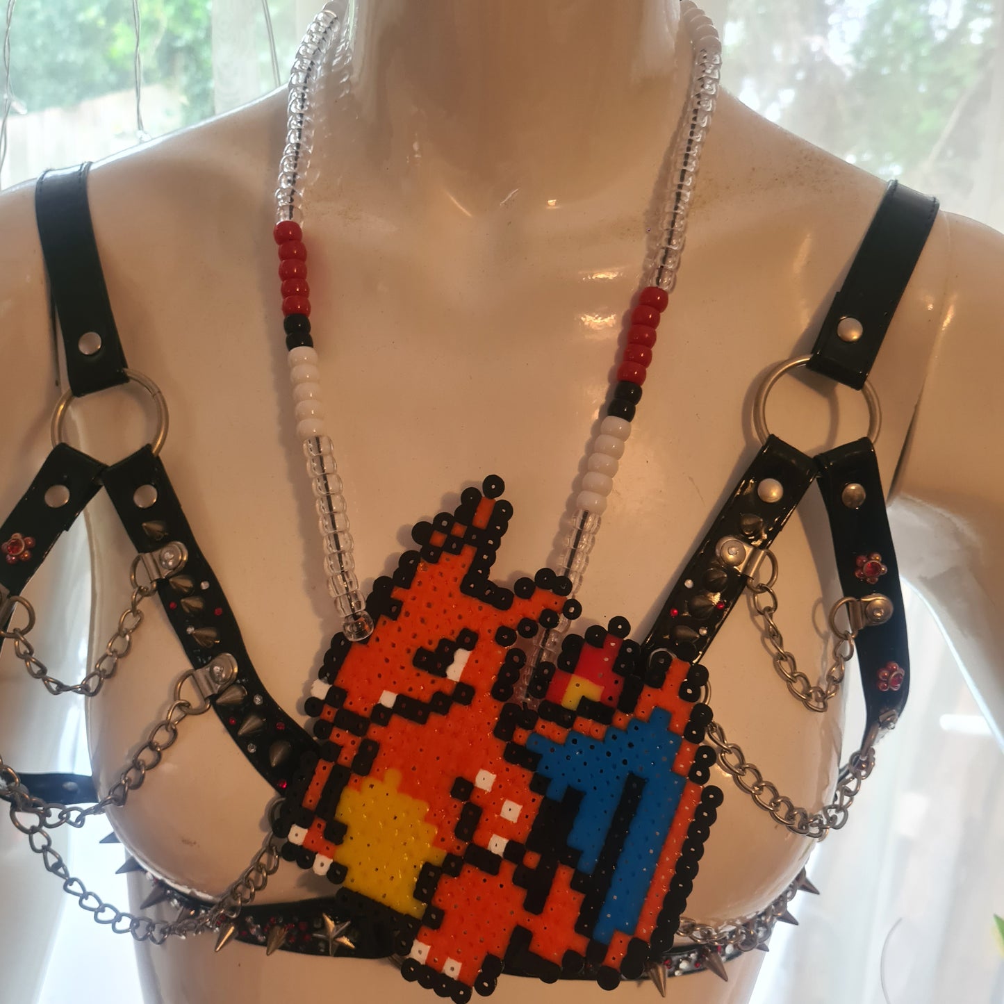 Pixelated character necklace on mannequin