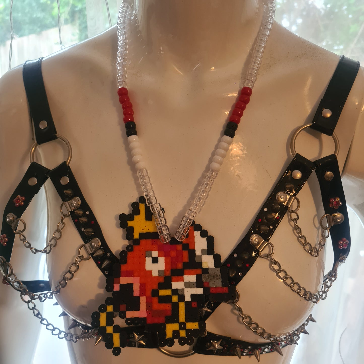 Pixelated character necklace on mannequin