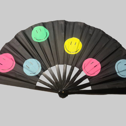 Smiley UV Fan, black handpainted with multicoloured smiley faces, UV reactive for festivals and raves
