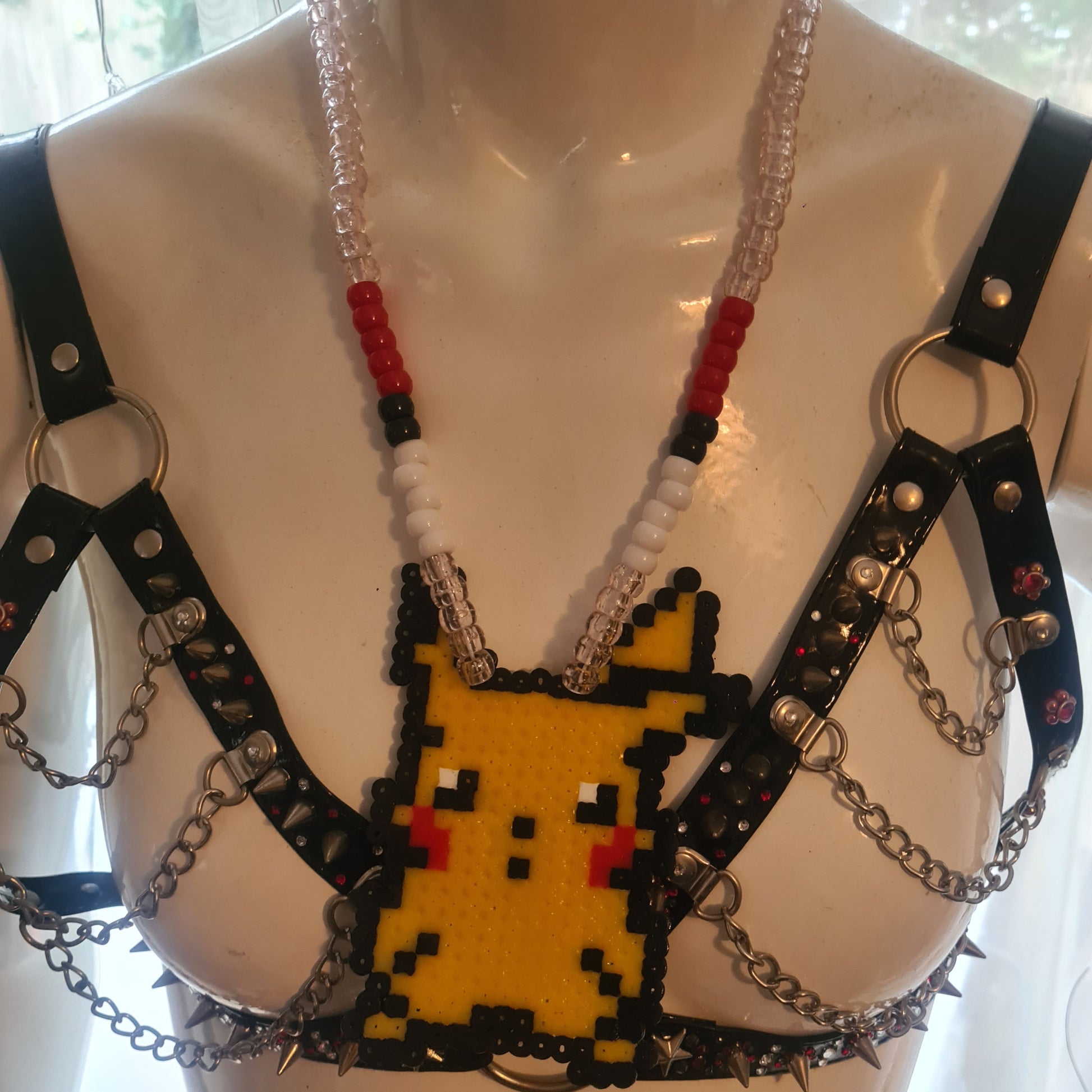Pixelated character necklace on mannequin