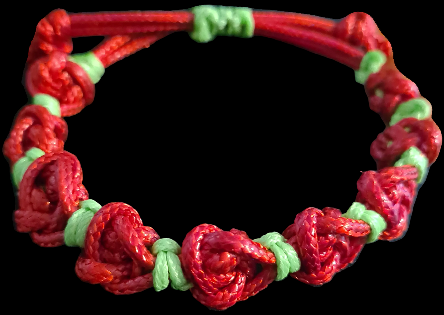 Red and green braided bracelet on a black background